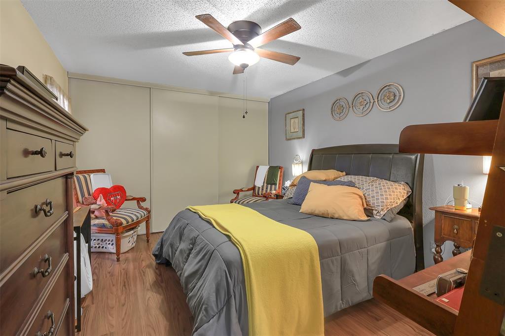 5624 Boca Raton Boulevard, Unit 133 Fort Worth, TX 76112 - Photo 8 of 19 a bedroom with two beds and a chandelier