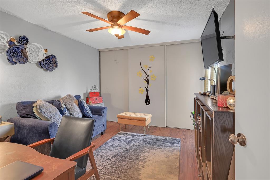 5624 Boca Raton Boulevard, Unit 133 Fort Worth, TX 76112 - Photo 10 of 19 a living room with furniture and a wooden floor