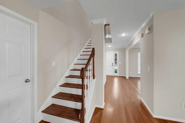 a view of a hallway with wooden floor and entryway