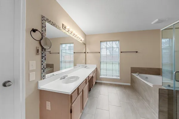 a spacious bathroom with a shower and a sink