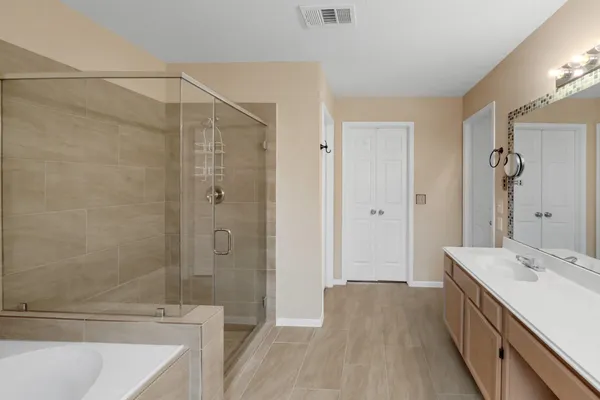 a view of walk in closet with empty racks