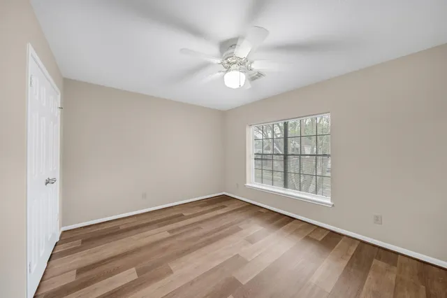 wooden floor in an empty room with a window