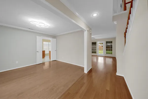 wooden floor in an empty room with a window