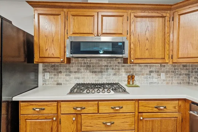 a living room with furniture flat screen tv and large window