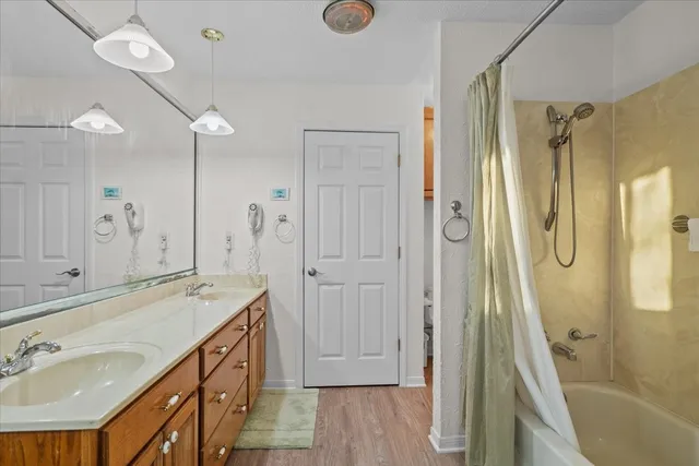 a bathroom with a granite countertop sink mirror and a shower