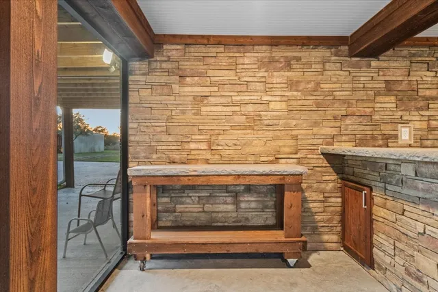 a view of a dining room with furniture large windows and wooden floor