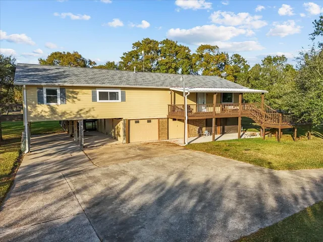 a view of a house with a yard and sitting area