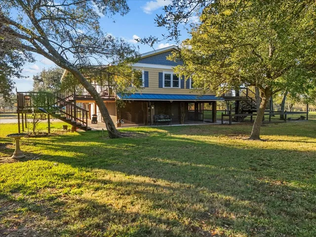 a large kitchen with stainless steel appliances kitchen island granite countertop a sink and a stove