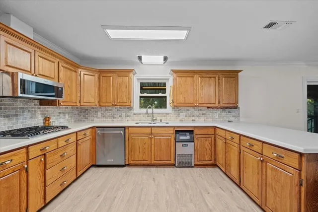 a kitchen with stainless steel appliances granite countertop a refrigerator and a sink