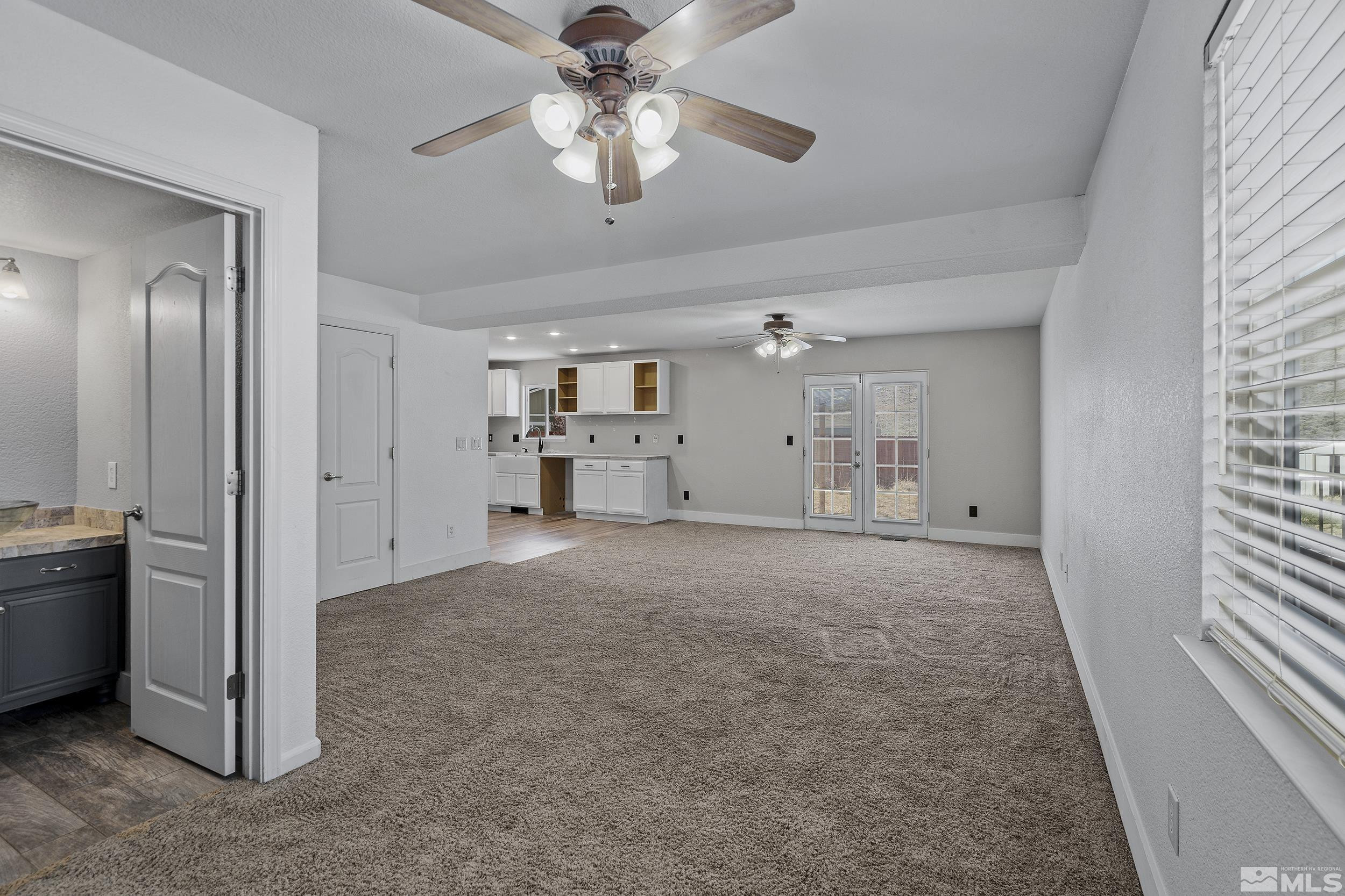 17940 Drift Creek Court Reno, NV 89508 - Photo 13 of 26 a view of a livingroom with a chandelier fan and windows