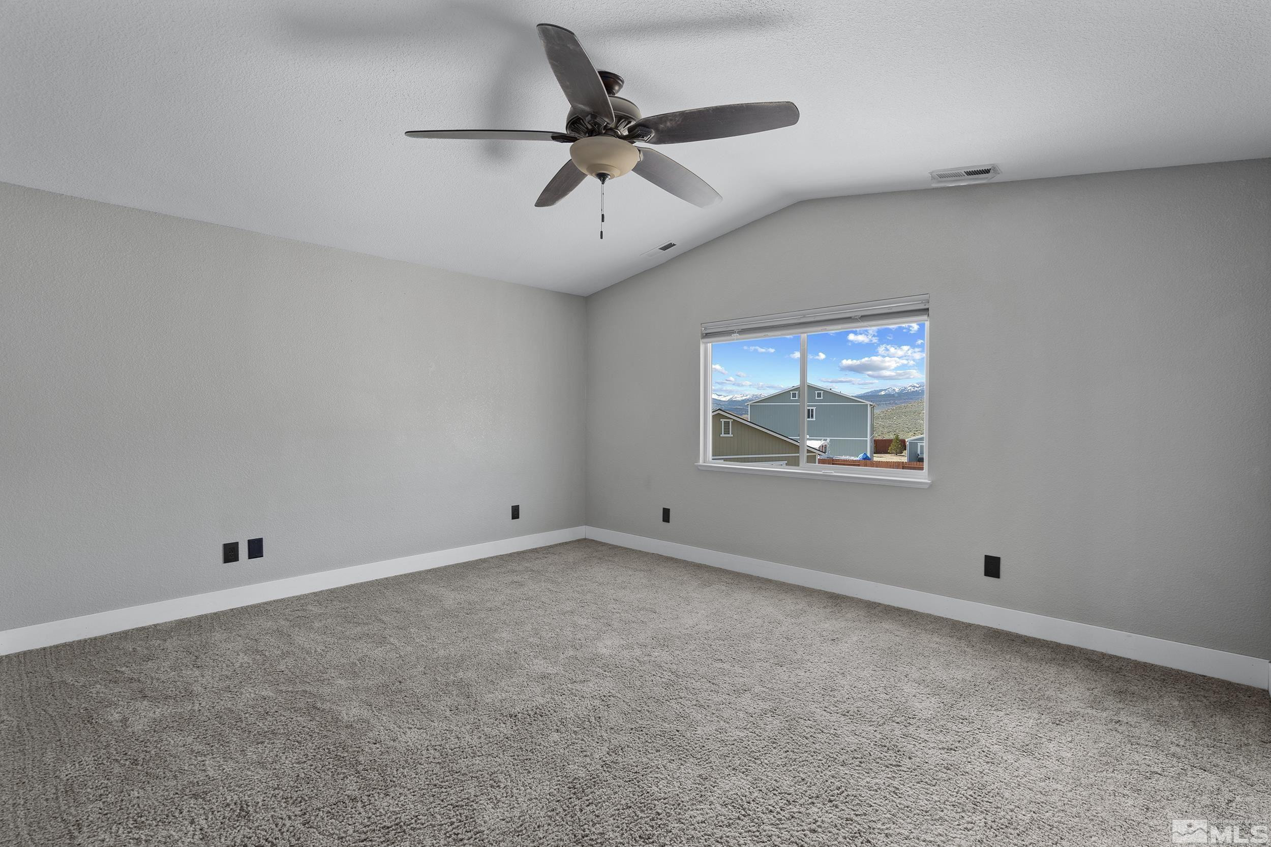 17940 Drift Creek Court Reno, NV 89508 - Photo 14 of 26 an empty room with a ceiling fan and window