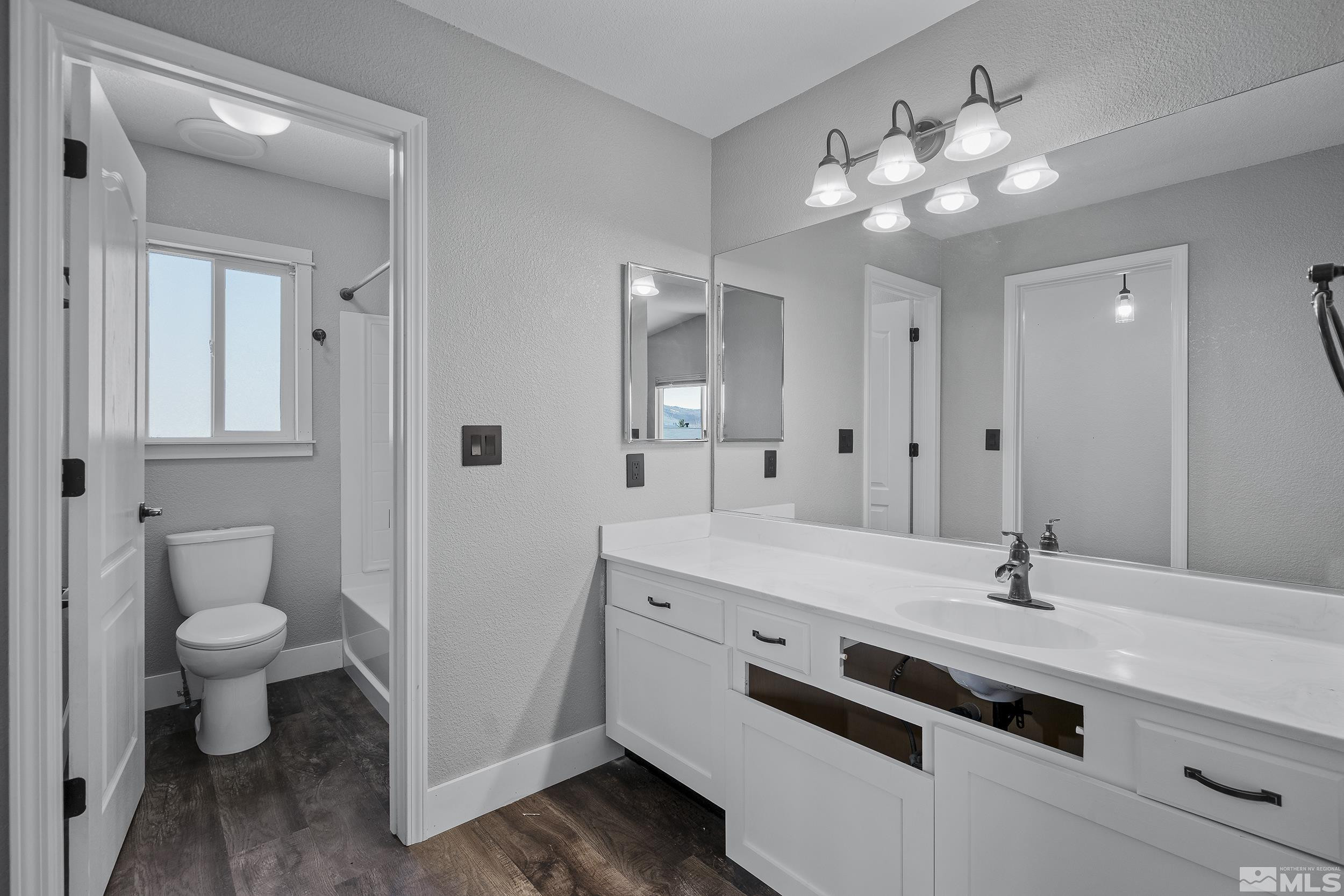 17940 Drift Creek Court Reno, NV 89508 - Photo 15 of 26 a spacious bathroom with a sink a toilet and a mirror