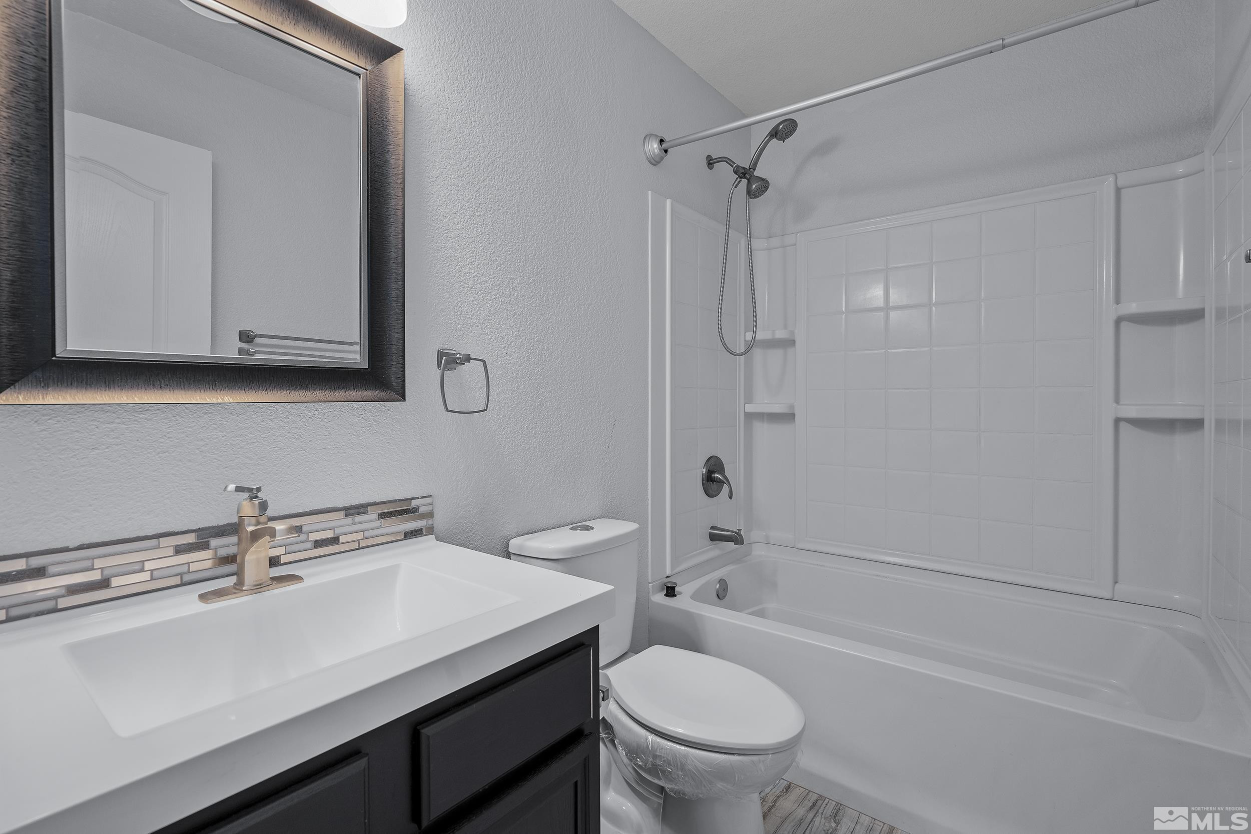 17940 Drift Creek Court Reno, NV 89508 - Photo 19 of 26 a bathroom with a sink toilet a mirror and shower