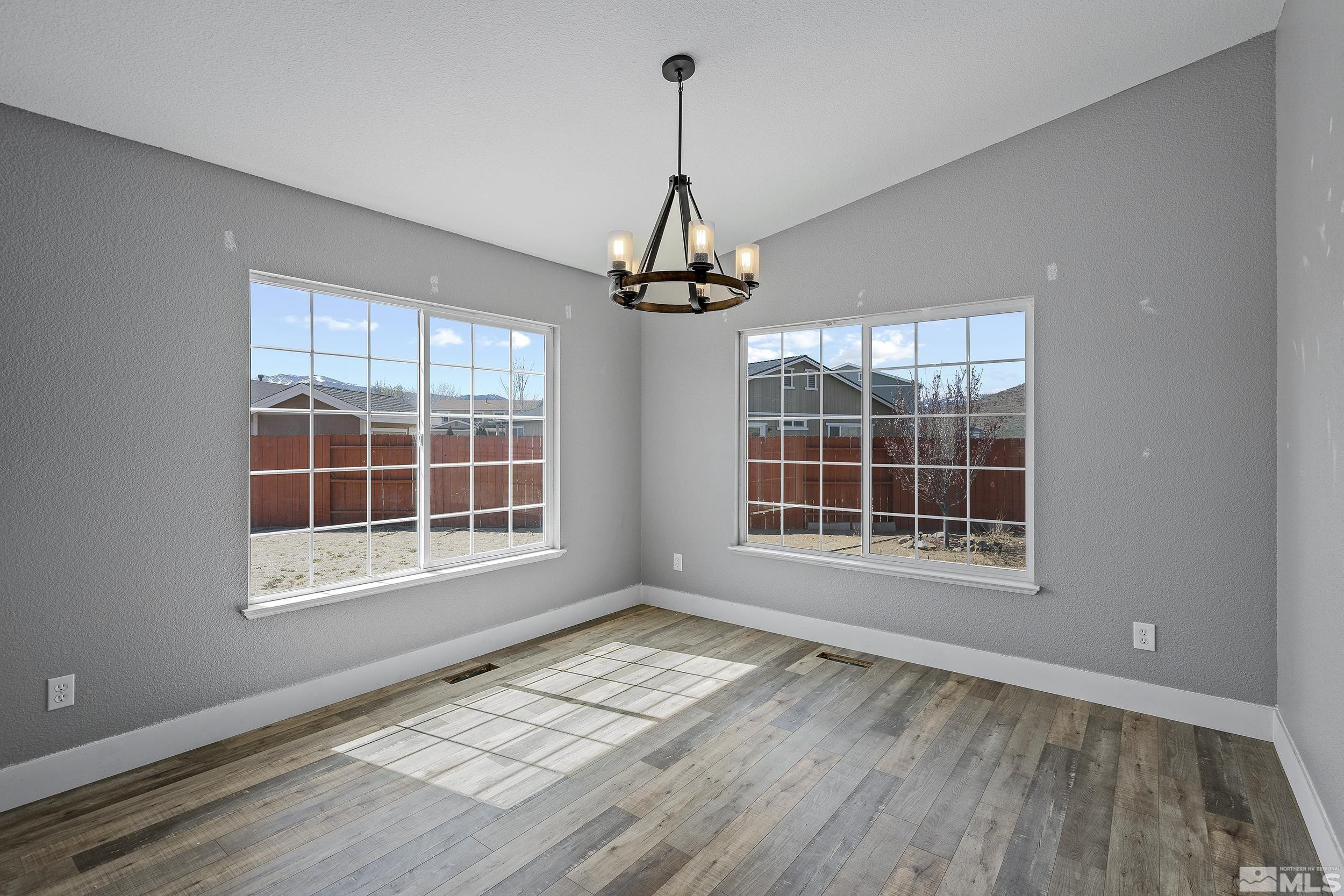 17940 Drift Creek Court Reno, NV 89508 - Photo 6 of 26 a view of an empty room with a window and wooden floor