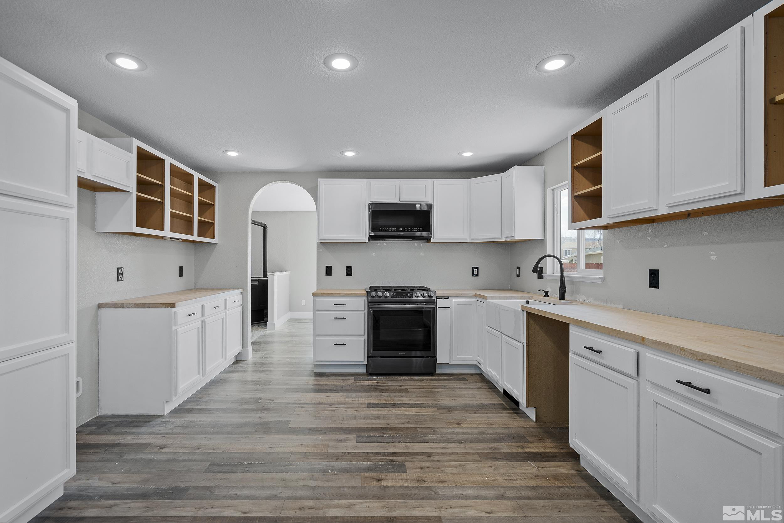 17940 Drift Creek Court Reno, NV 89508 - Photo 8 of 26 a large kitchen with stainless steel appliances granite countertop a lot of cabinets and wooden floor