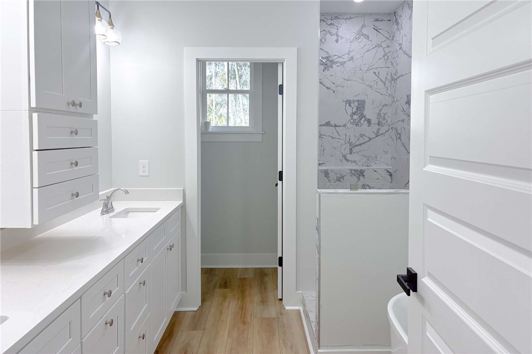 2515 Highway 29 Anderson, SC 29621 - Photo 24 of 38 Marble-tiled shower alongside a bright vanity with ample storage.
