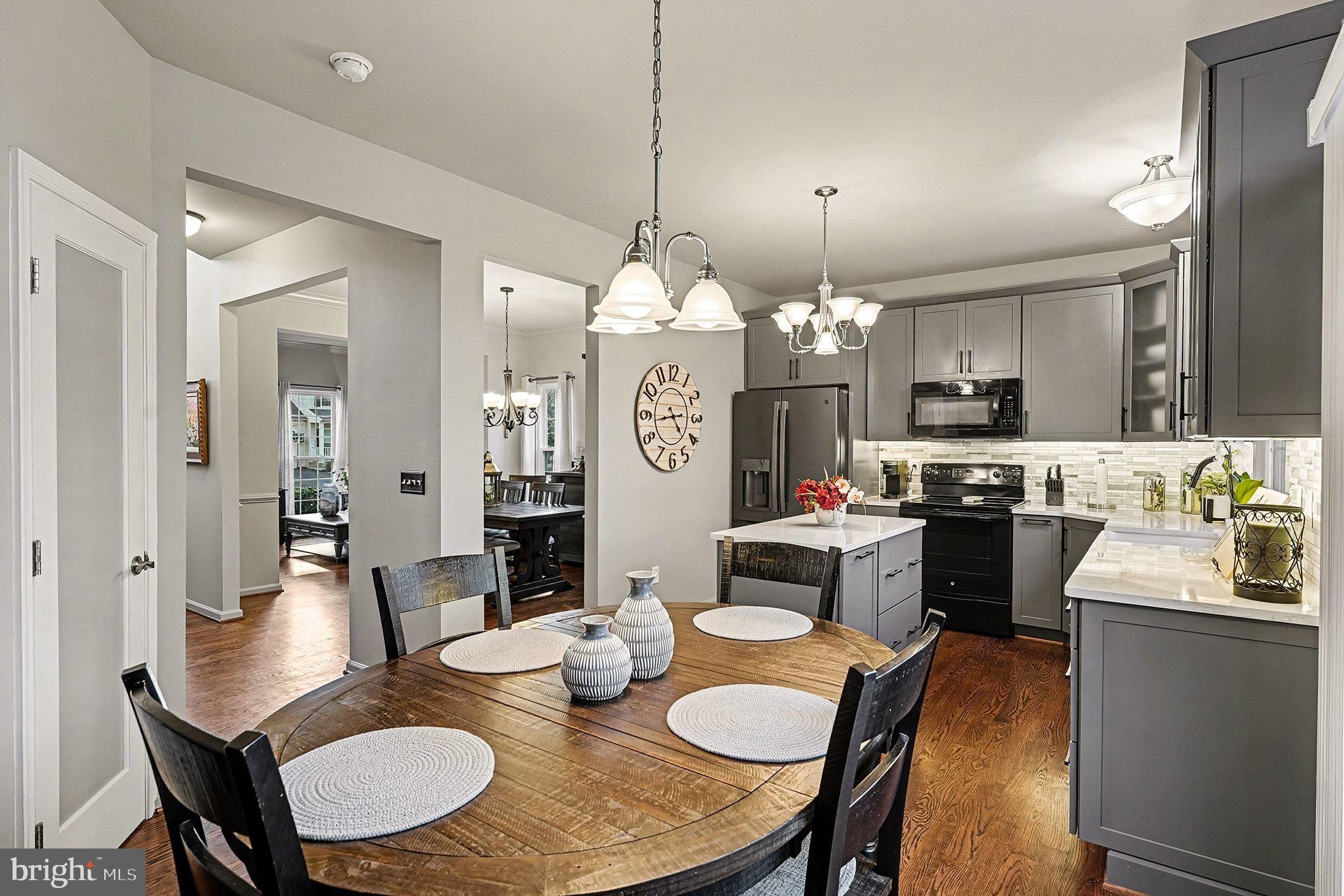 6465 Colonial Village Loop Manassas, VA 20112 - Photo 17 of 39 a view of a dining room with furniture a chandelier and wooden floor