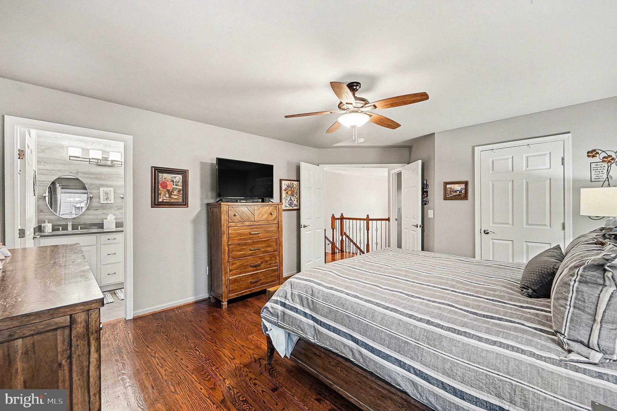6465 Colonial Village Loop Manassas, VA 20112 - Photo 20 of 39 a bedroom with a bed and a flat screen tv