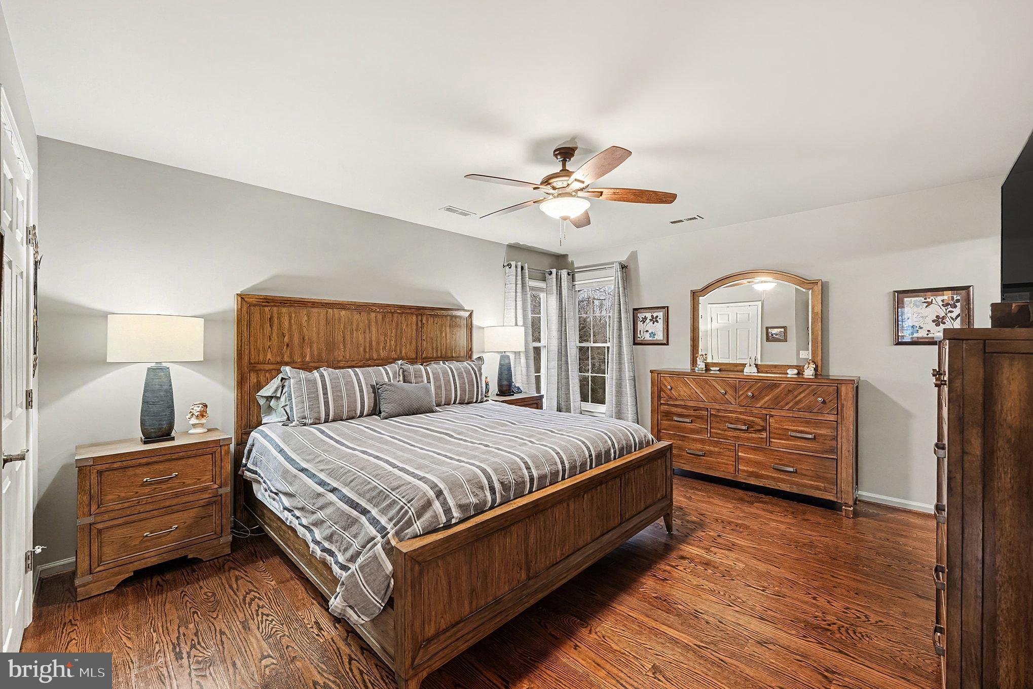 6465 Colonial Village Loop Manassas, VA 20112 - Photo 21 of 39 a bedroom with a bed a couch and dresser
