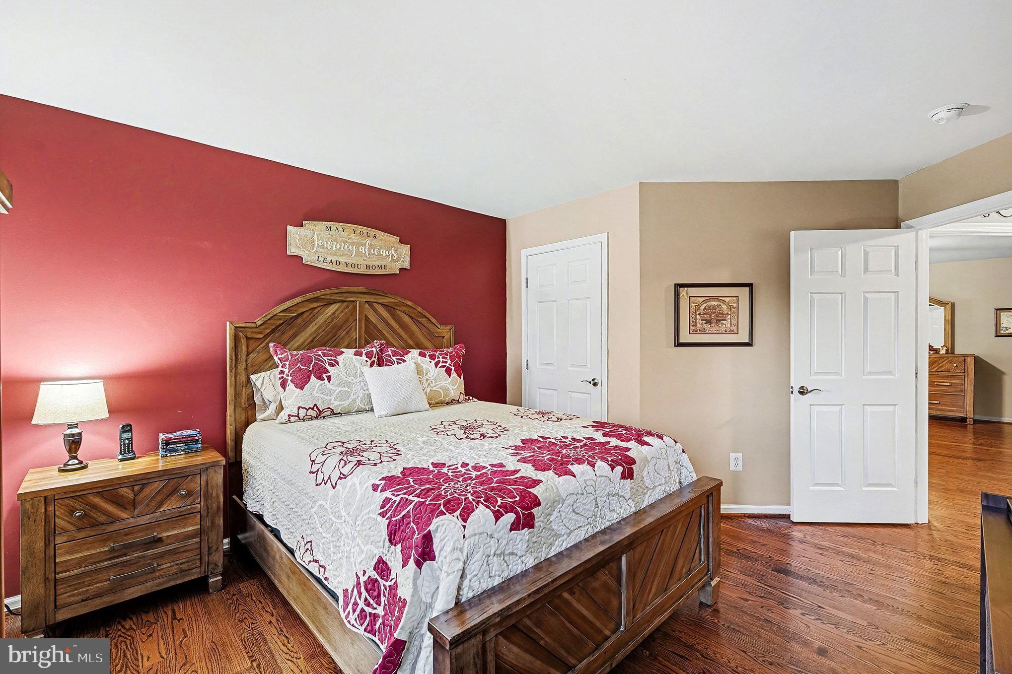 6465 Colonial Village Loop Manassas, VA 20112 - Photo 24 of 39 a bedroom with a bed and wooden floor