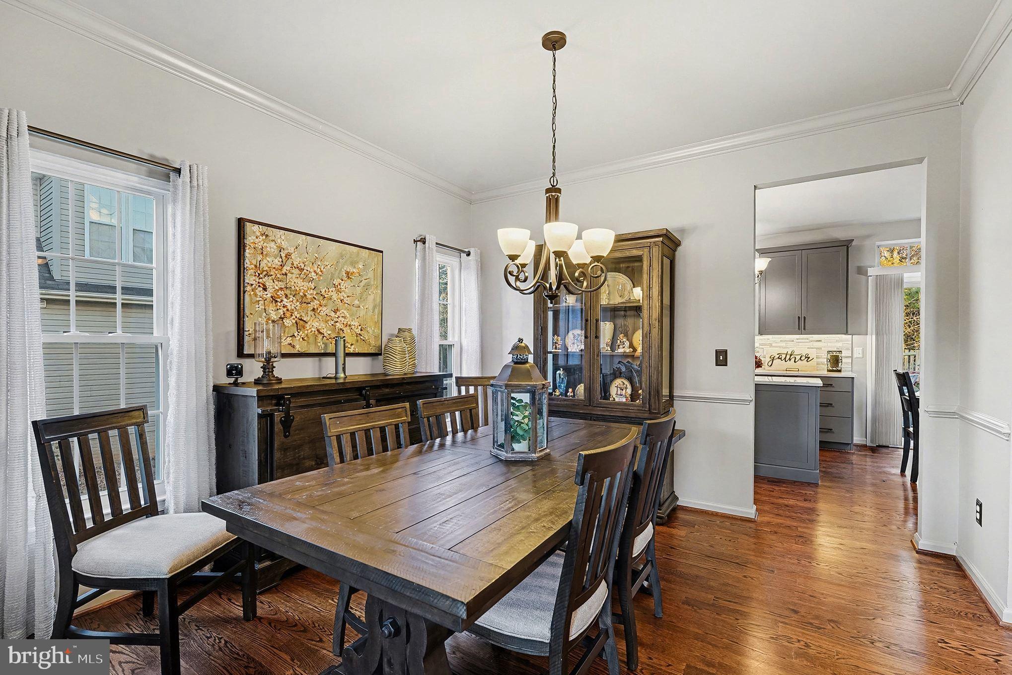 6465 Colonial Village Loop Manassas, VA 20112 - Photo 9 of 39 a view of a dining room and livingroom with furniture wooden floor a chandelier