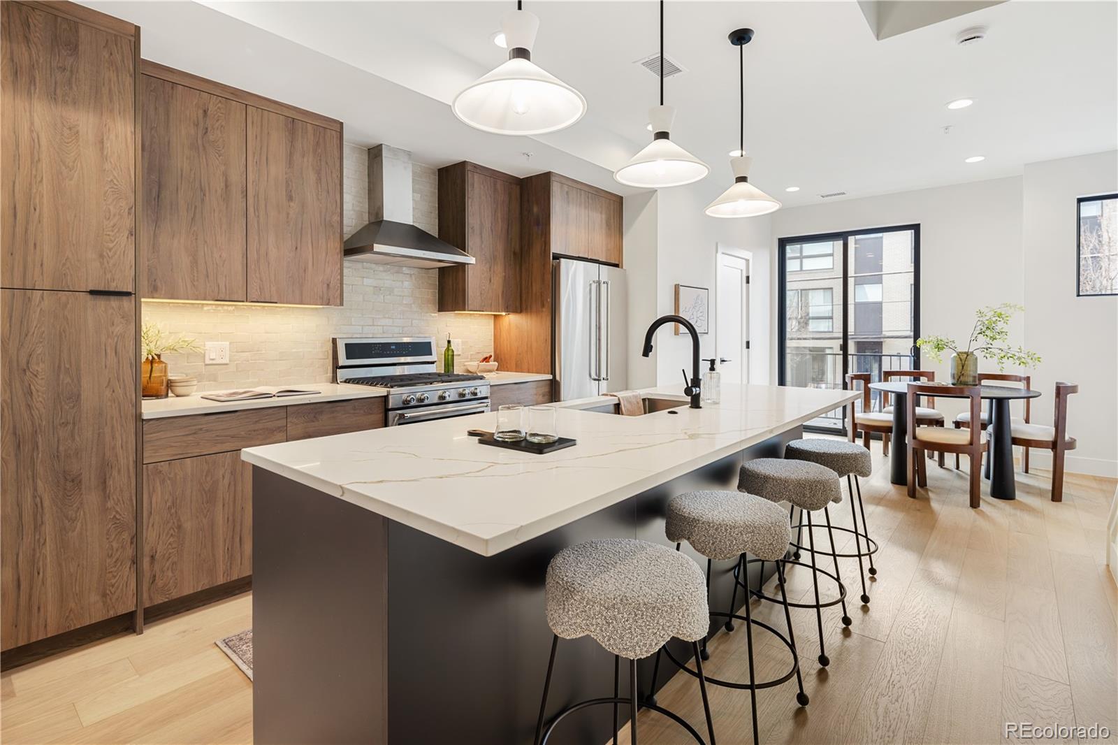 4511 Tennyson Street Denver, CO 80212 - Photo 1 of 34 a kitchen with a dining table chairs sink and cabinets