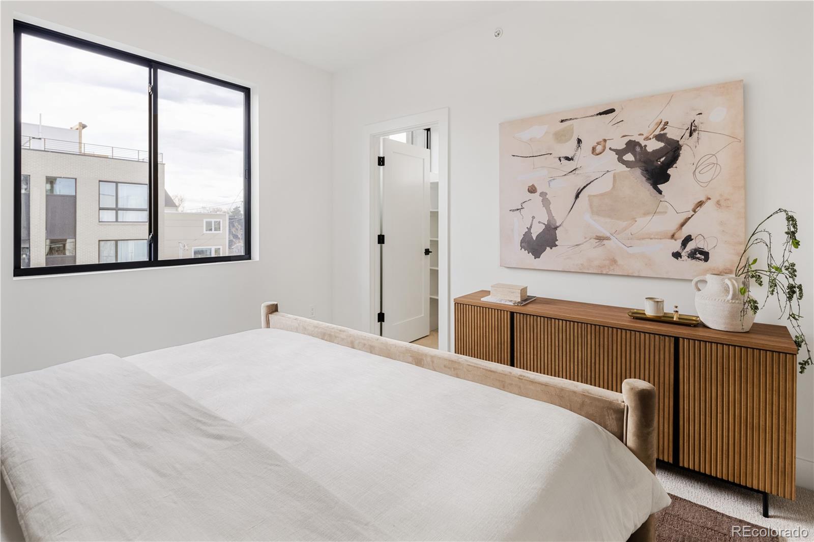 4511 Tennyson Street Denver, CO 80212 - Photo 15 of 34 a bedroom with a large bed and a window