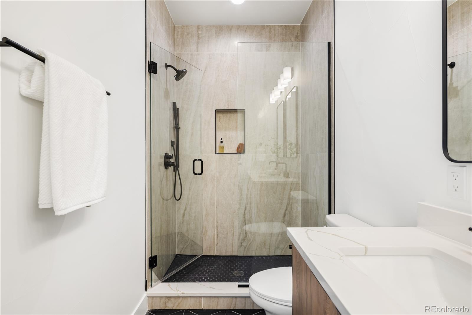 4511 Tennyson Street Denver, CO 80212 - Photo 19 of 34 a bathroom with a sink a toilet and shower