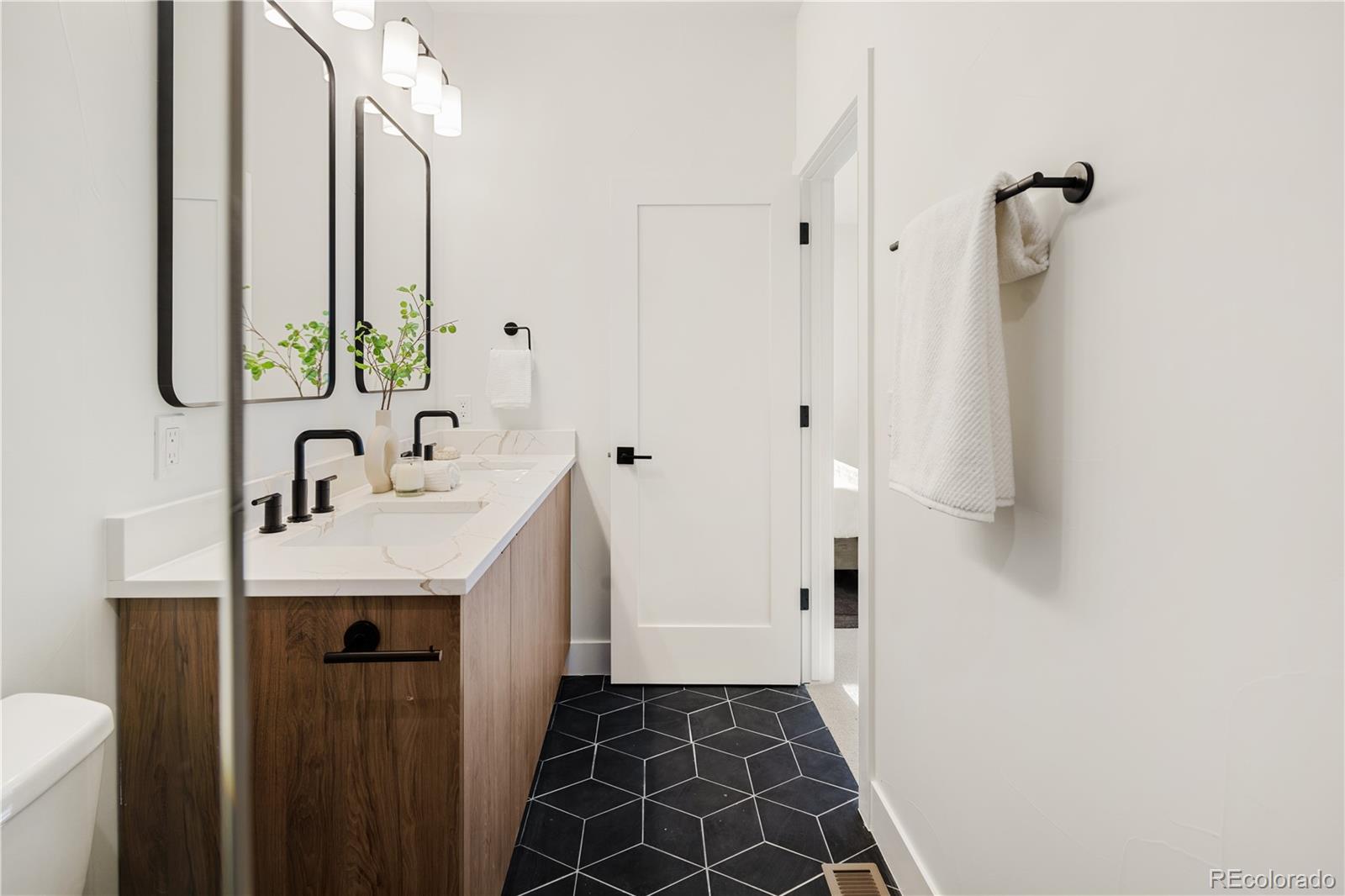 4511 Tennyson Street Denver, CO 80212 - Photo 20 of 34 a bathroom with a sink and a mirror
