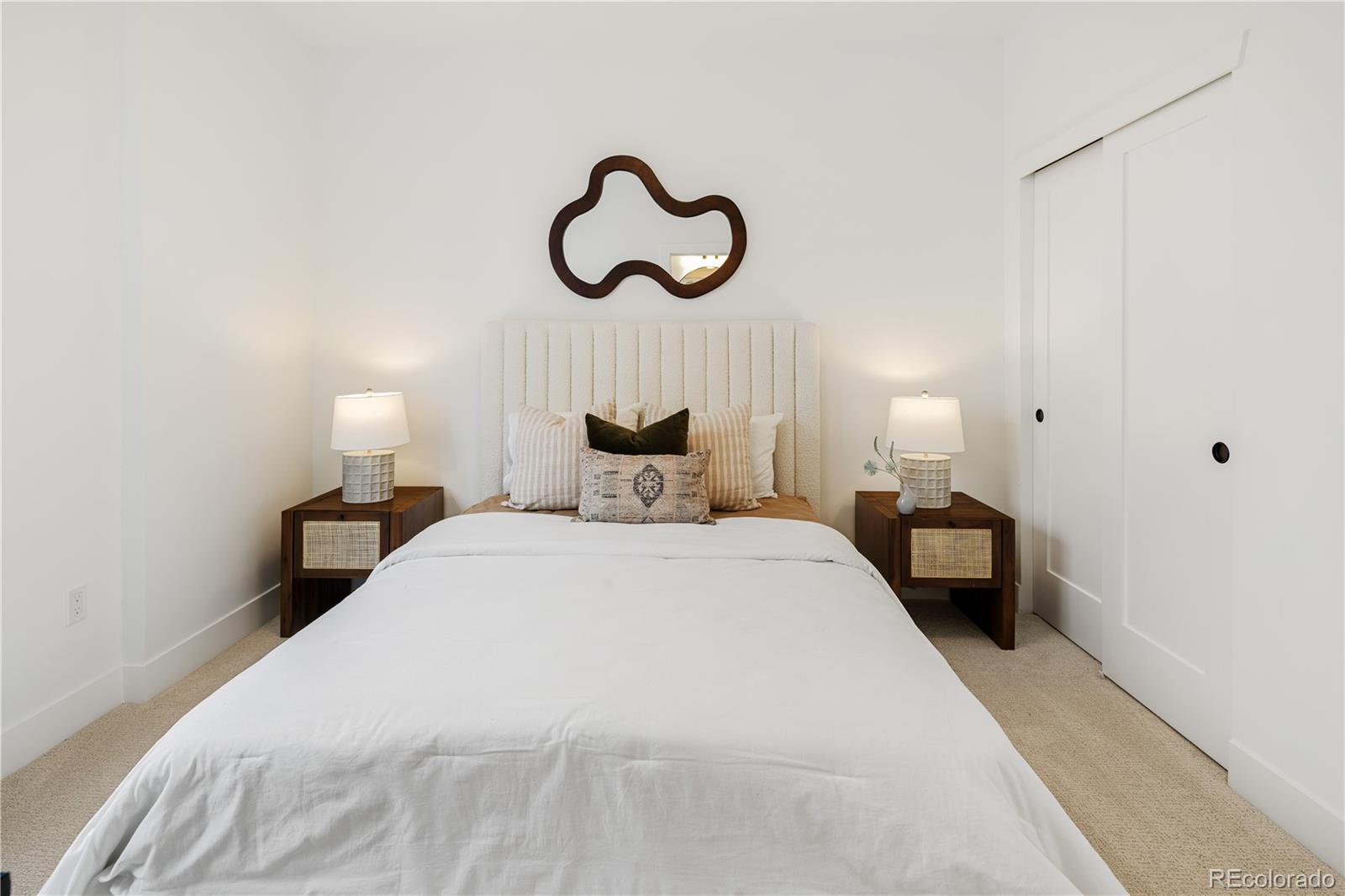 4511 Tennyson Street Denver, CO 80212 - Photo 22 of 34 a bedroom with bed and a chandelier