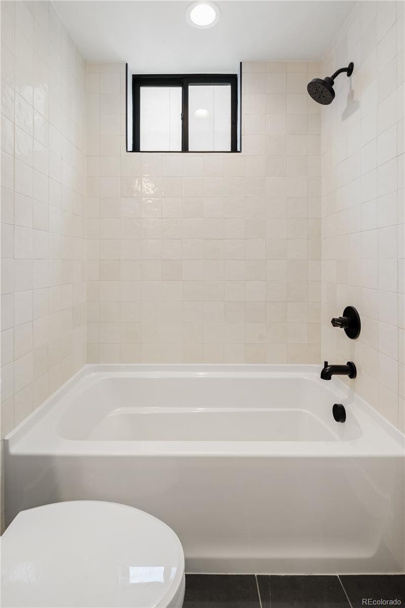 4511 Tennyson Street Denver, CO 80212 - Photo 25 of 34 a bathroom with a bathtub and a shower