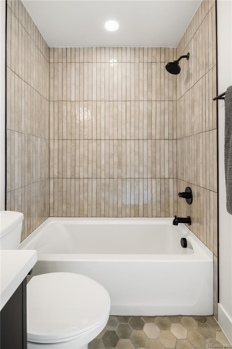 4511 Tennyson Street Denver, CO 80212 - Photo 28 of 34 a bathroom with a bathtub and shower