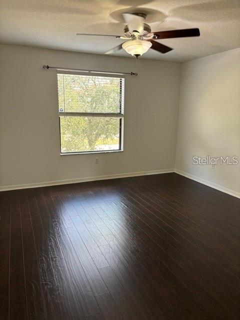 2417 Hibiscus Bay Lane Brandon, FL 33511 - Photo 20 of 36 an empty room with wooden floor chandelier fan and windows