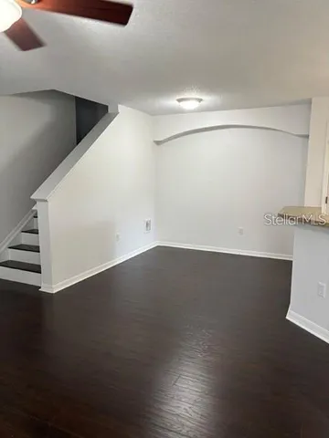 a view of a room with wooden floor
