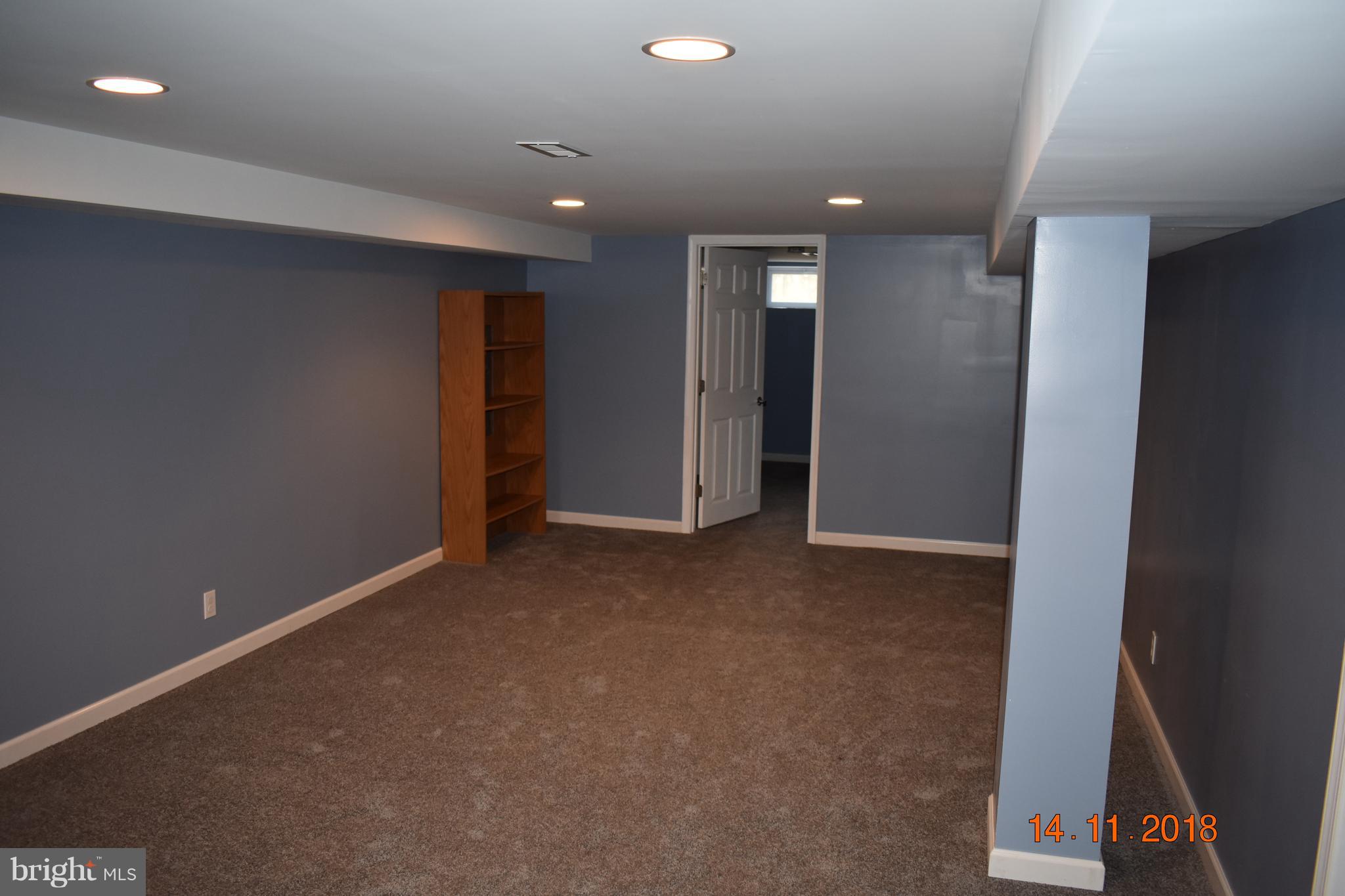 1905 Ridgewick Road Glen Burnie, MD 21061 - Photo 15 of 25 finished basement open area door goes into bedroom