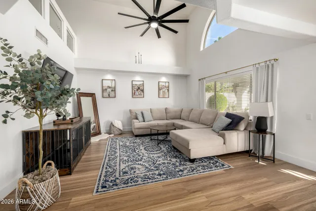 a living room with furniture and view of kitchen