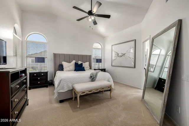 a bedroom with a bed and a chandelier