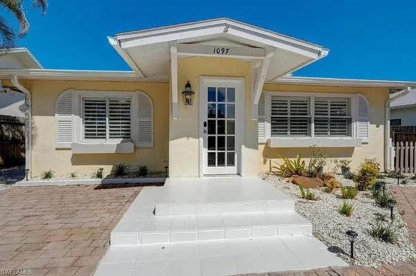 a front view of a house with outdoor seating