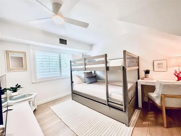 a bedroom with two beds and a table