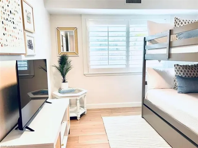 a spacious bedroom with a bed and a table