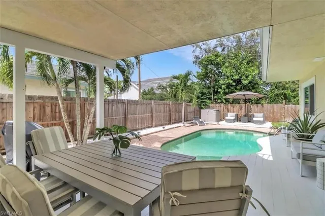 a view of a patio with a table chairs and a potted plant
