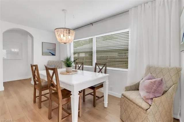 a view of a dining room with furniture and chandelier