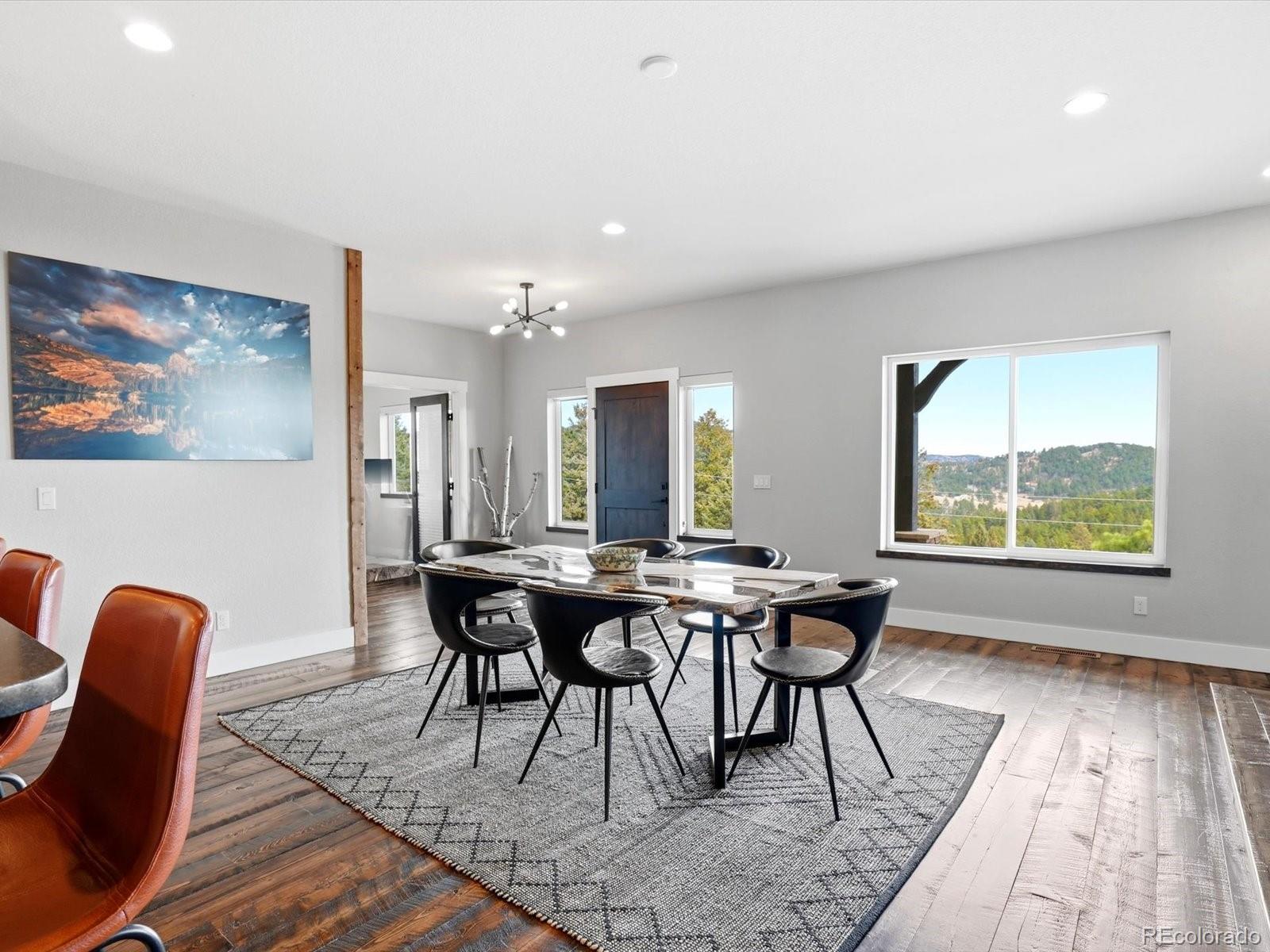7333 Plowsher Way Morrison, CO 80465 - Photo 11 of 36 a view of a dining room with furniture and wooden floor