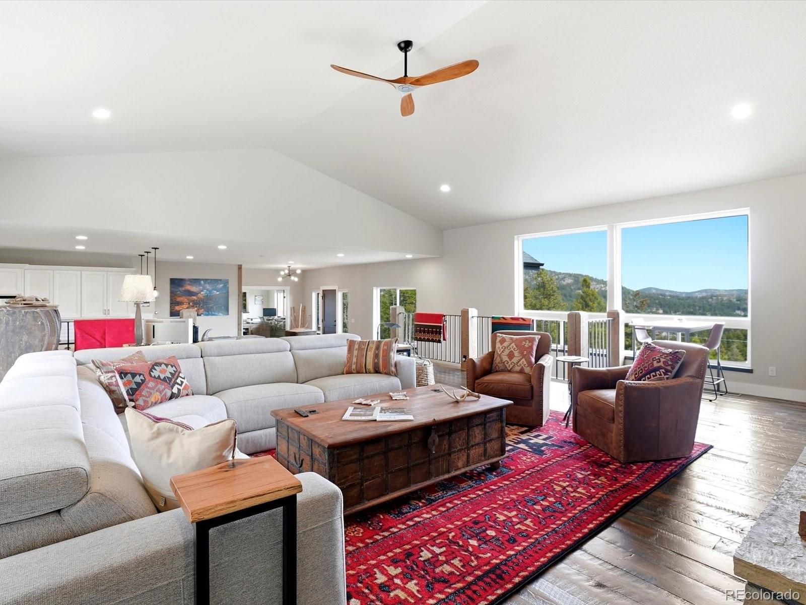 7333 Plowsher Way Morrison, CO 80465 - Photo 13 of 36 a living room with furniture fireplace and a large window