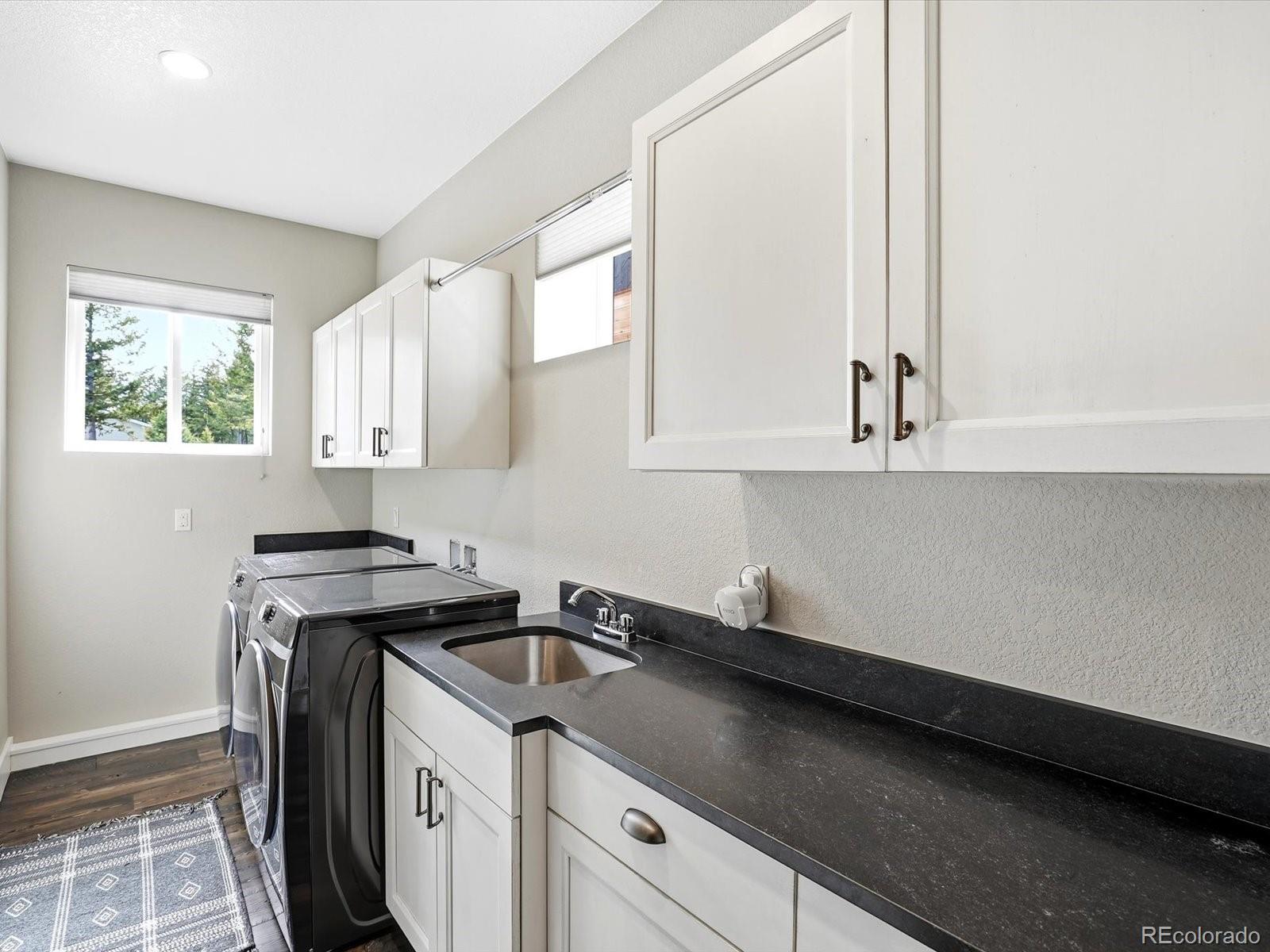 7333 Plowsher Way Morrison, CO 80465 - Photo 22 of 36 a kitchen with stainless steel appliances granite countertop a sink a stove and a granite counter tops with a window