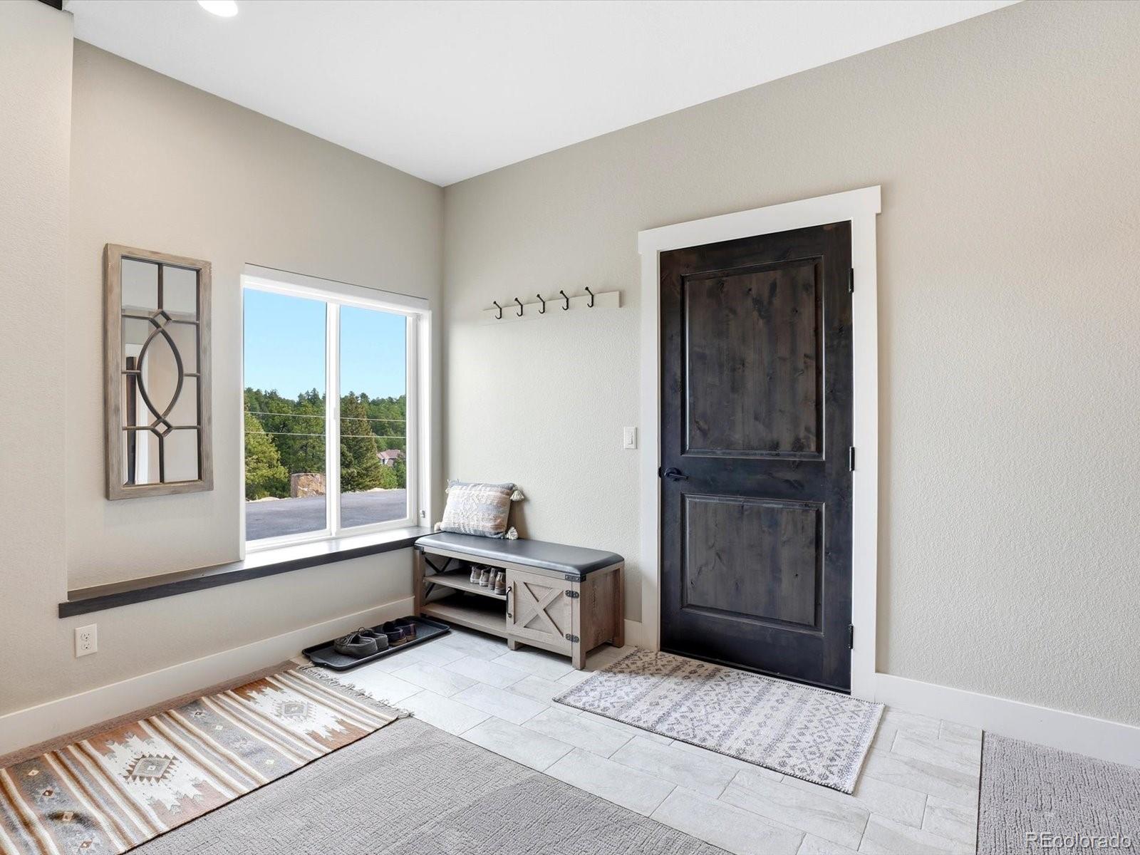 7333 Plowsher Way Morrison, CO 80465 - Photo 23 of 36 a living room with furniture and a window