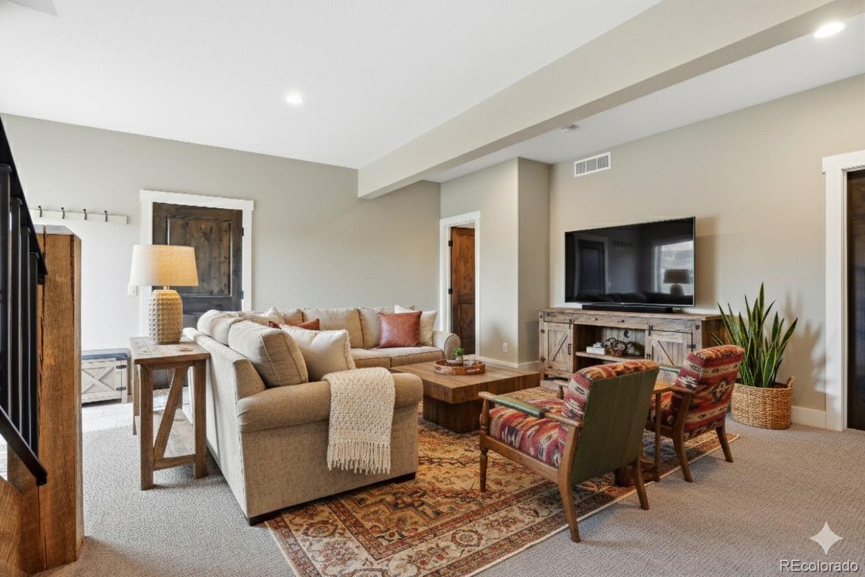 7333 Plowsher Way Morrison, CO 80465 - Photo 24 of 36 a living room with furniture and a flat screen tv