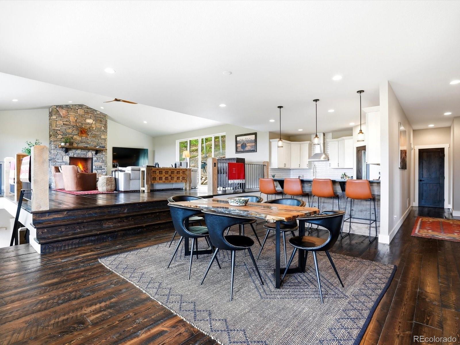 7333 Plowsher Way Morrison, CO 80465 - Photo 5 of 36 a living room with lots of furniture and a rug