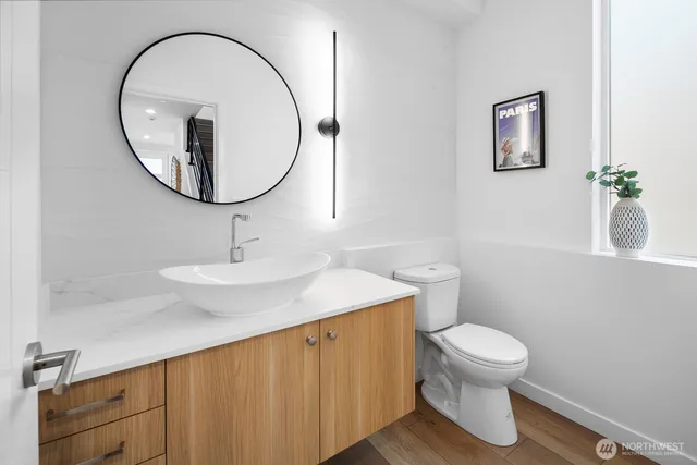 a bathroom with a sink a mirror and a toilet