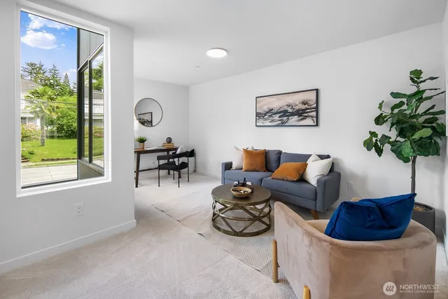 a living room with furniture and a potted plant